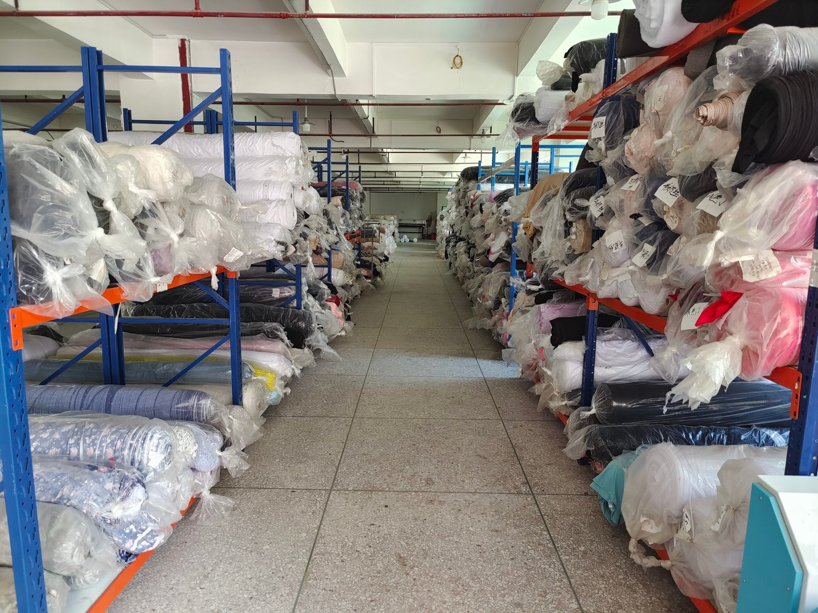 Vetting a Supplier with a Remote Factory Audit alt with keywords: A buyer conducting a live video factory tour on a tablet with a supplier