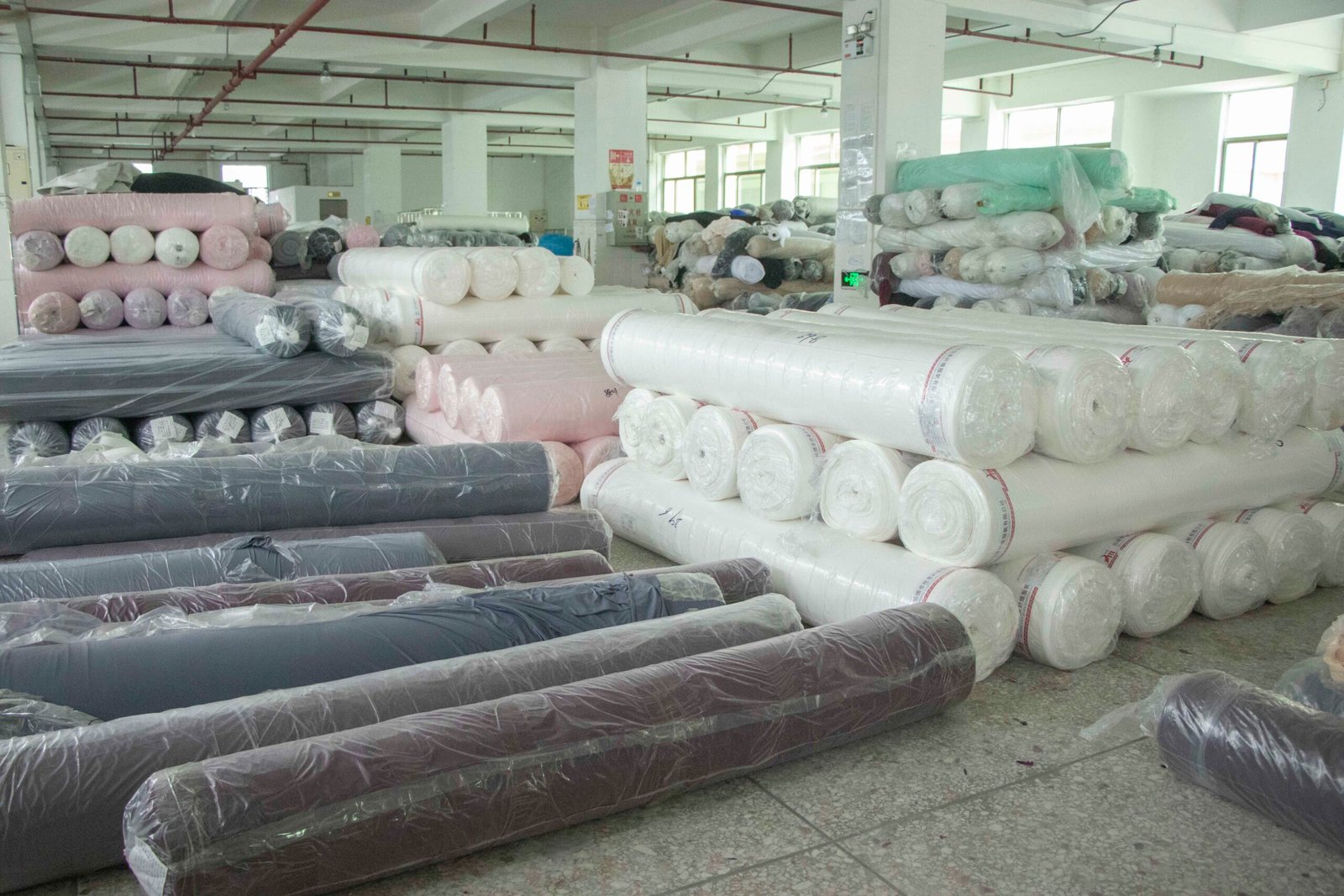 Fabric quality check process Inspector checking a roll of fabric on a machine