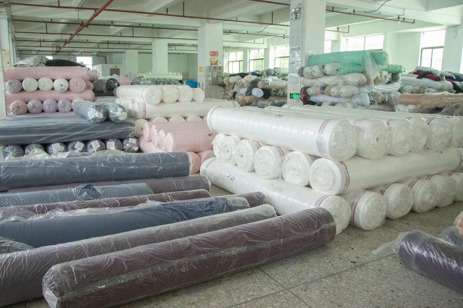 Good vs Great Undergarment Supplier alt with keywords: A factory manager showing a brand owner innovative new fabric options