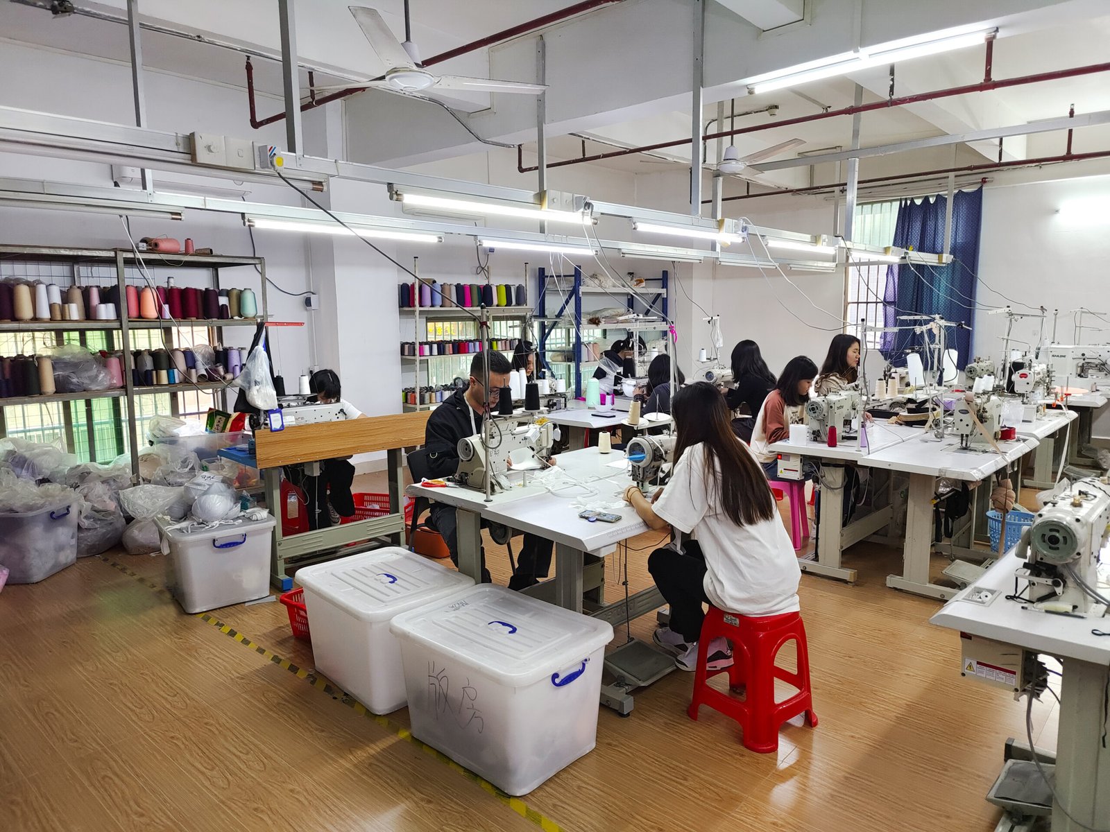 Essentials of Full-Breast Bra Production alt with keywords: Fabric swatches and sewing patterns for a full-breast bra on a cutting table