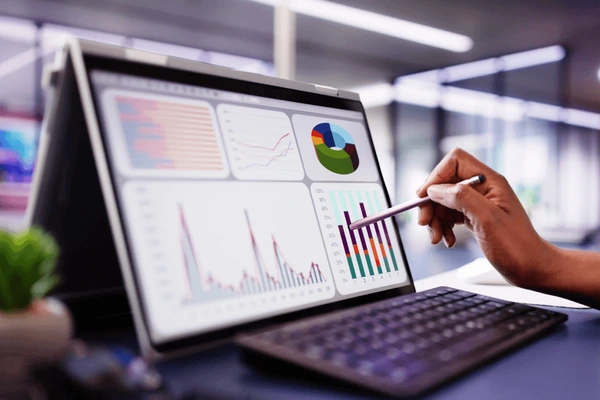 Using Data and Technology in B2B Bra Sourcing alt with keywords: A laptop screen displaying a sales analytics dashboard for different bra sizes and styles